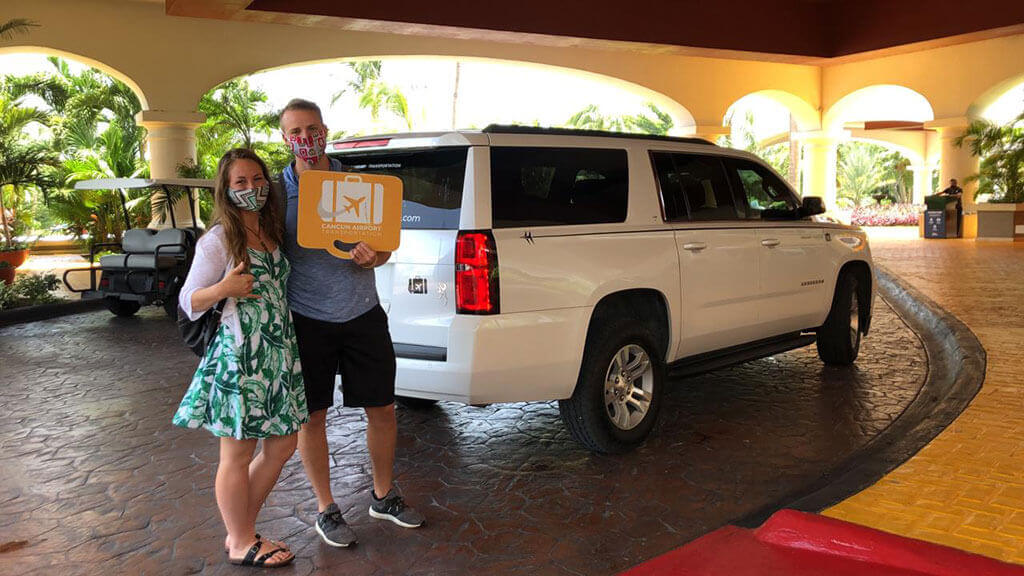 Couple arriving to their hotel by white Luxury SUV